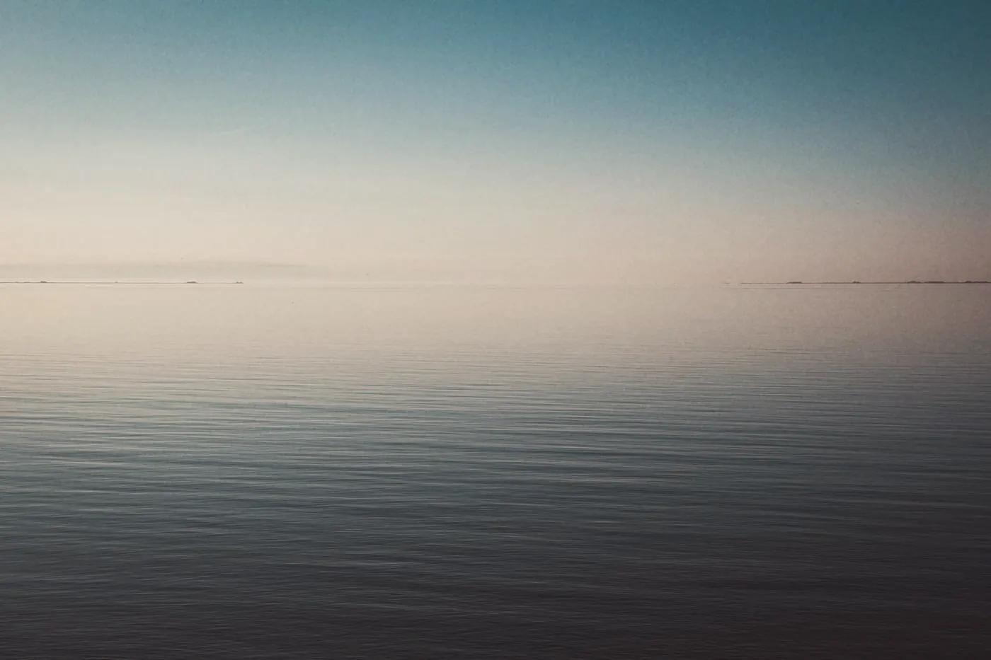 A calm sea under a clear sky at dawn, a moment to pause and plan the next step
