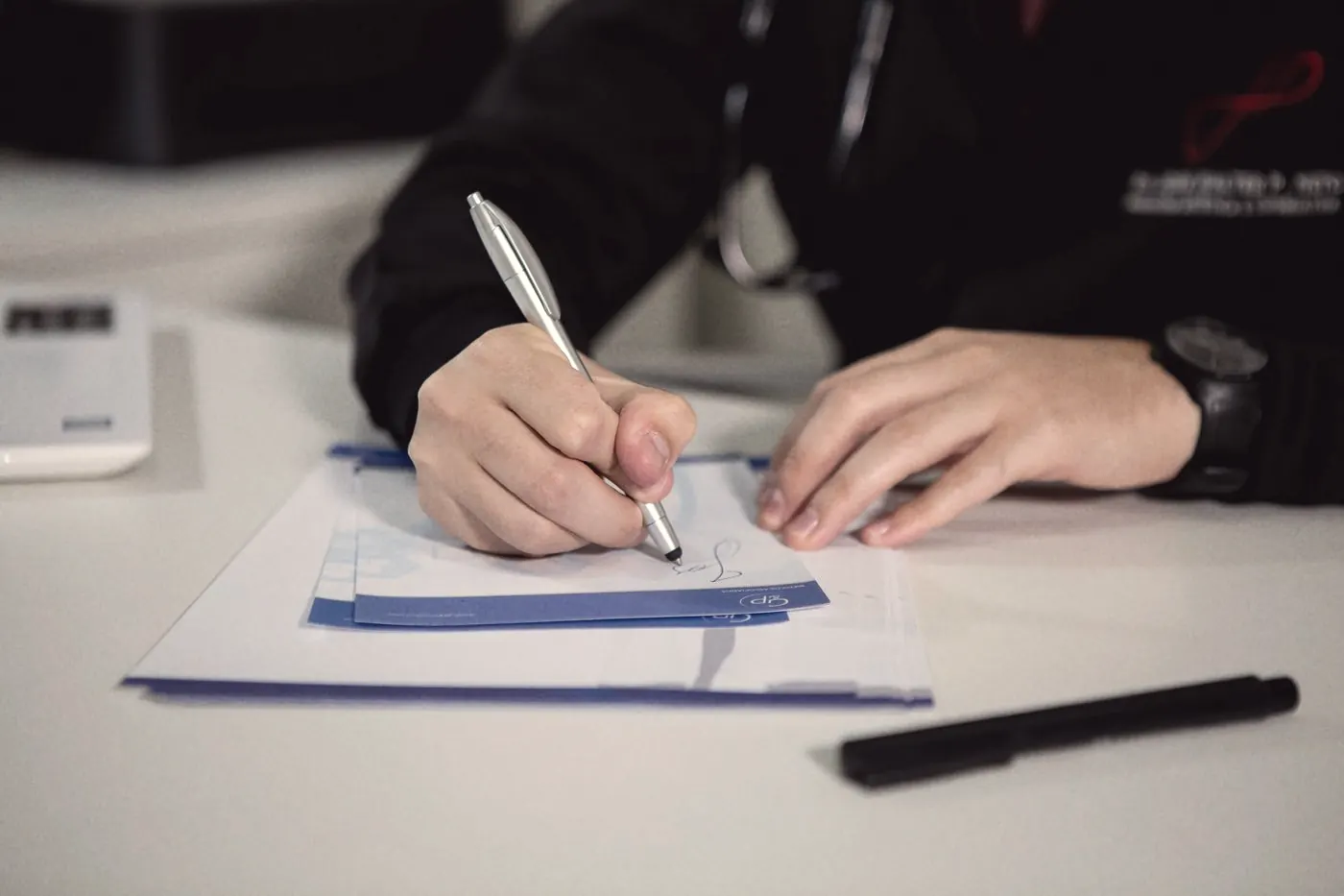 A doctor writing a paper prescription, which PEP requires in Thailand