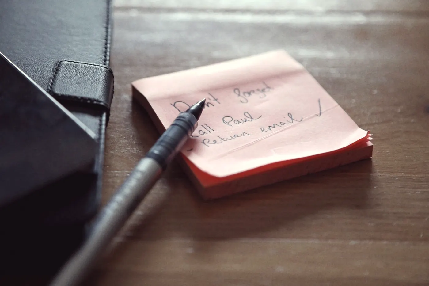 Handwritten sticky notes with a short to-do list and a pen, planning the next steps after a risk