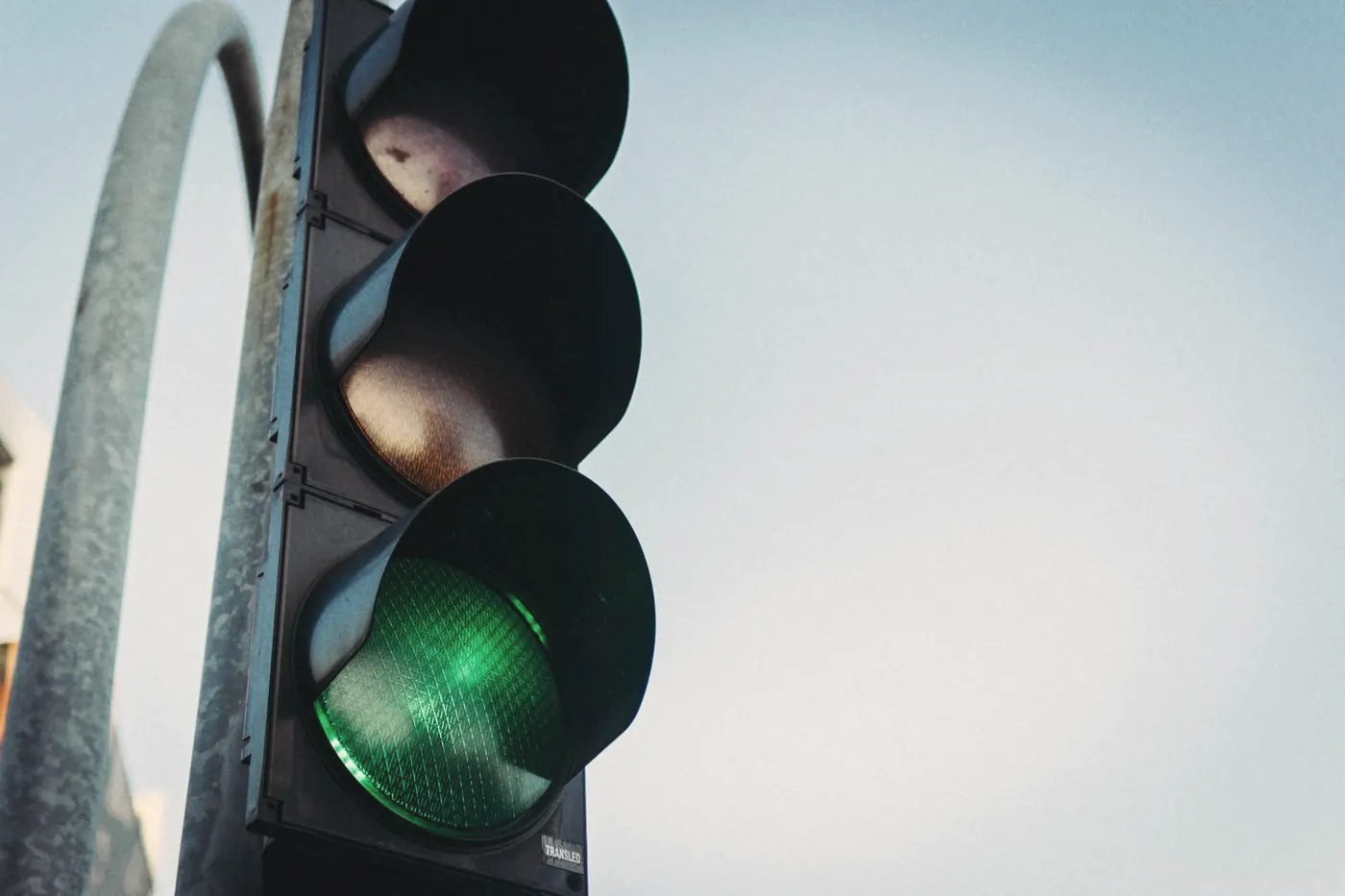 A green traffic light against a clear blue sky, showing that touch and massage carry no HIV risk