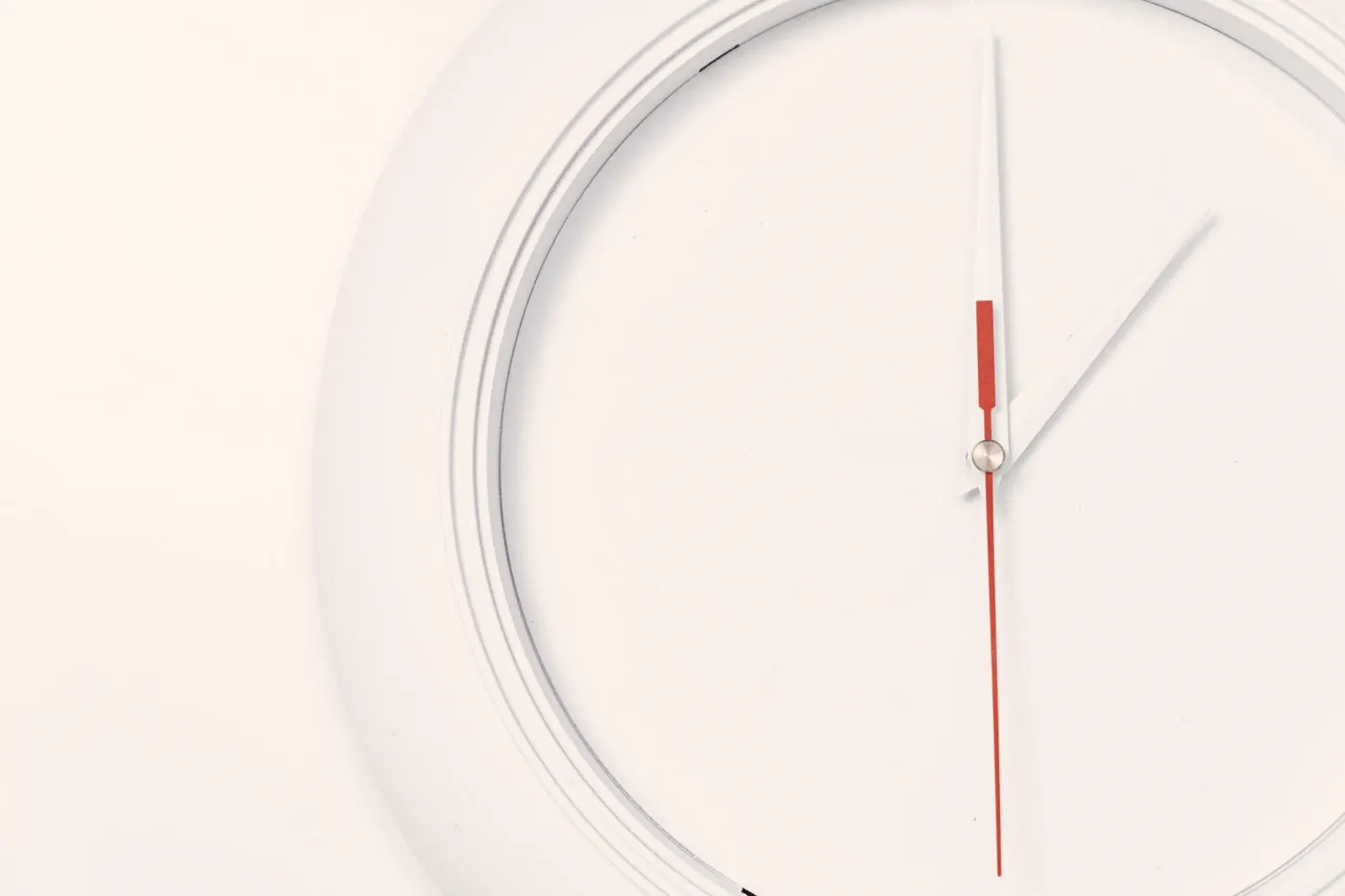 A minimalist wall clock, a reminder that delaying PEP costs time