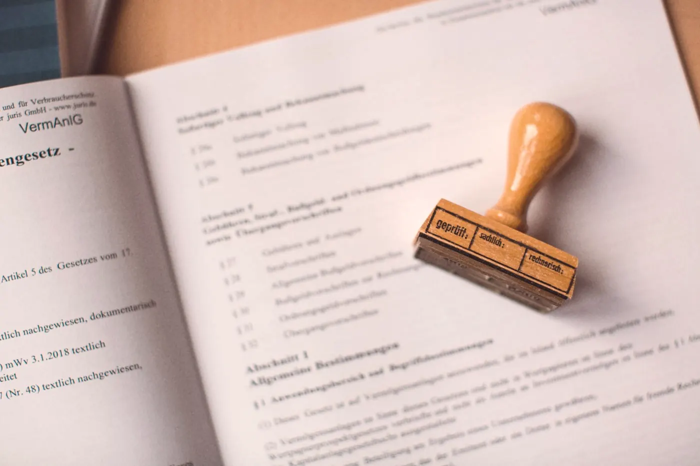 An official document with a wooden rubber stamp resting on it, like a work injury report