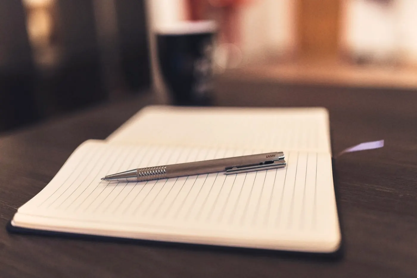 An open notebook and pen on a table, ready for a simple symptom diary during PEP