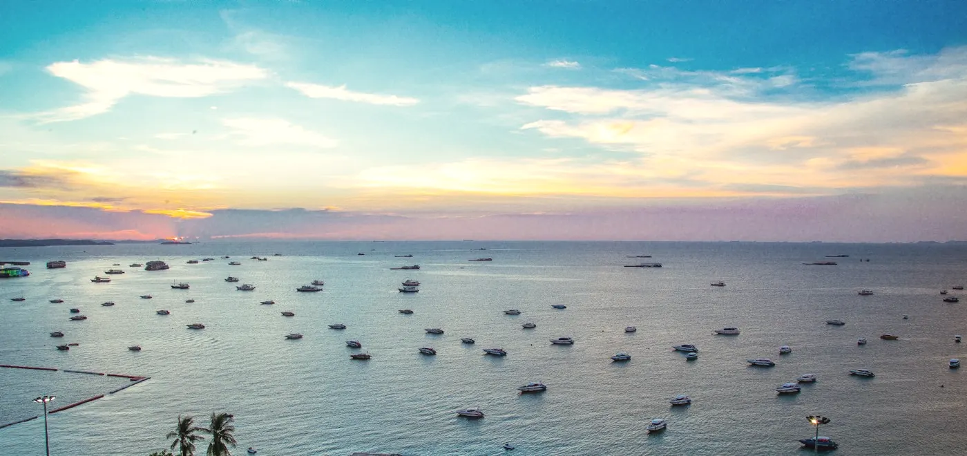 Boats moored in Pattaya Bay on a clear day