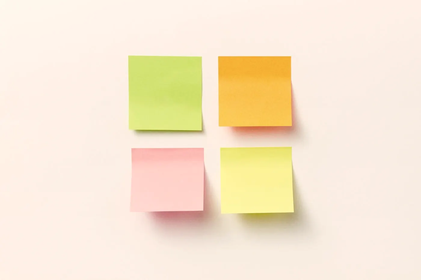 Four colourful sticky notes on a white background, one for each week of the first month on PrEP