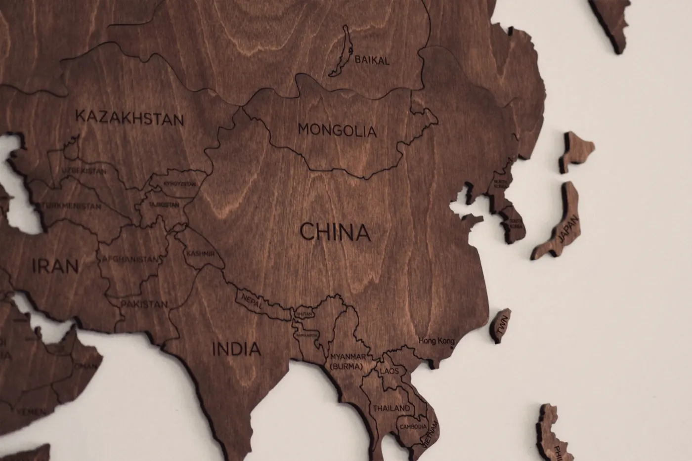 A wooden wall map of Asia, a reminder that national data doesn't show every city
